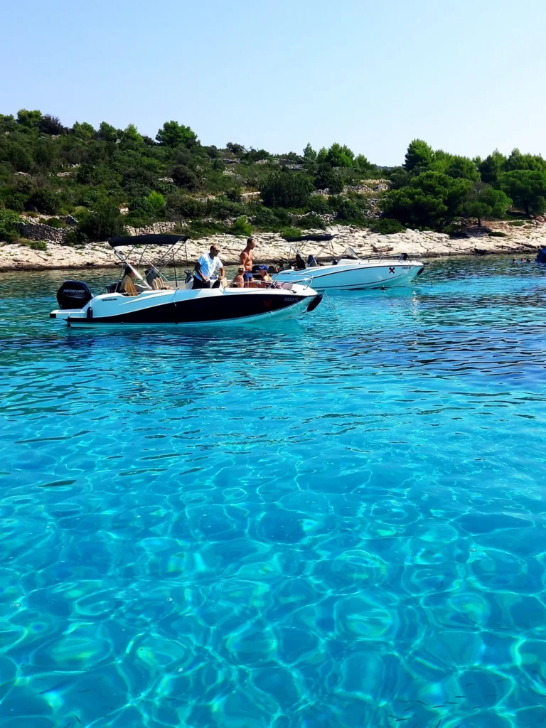 Modern rental boat anchored in Split Croatia for daily island excursions.